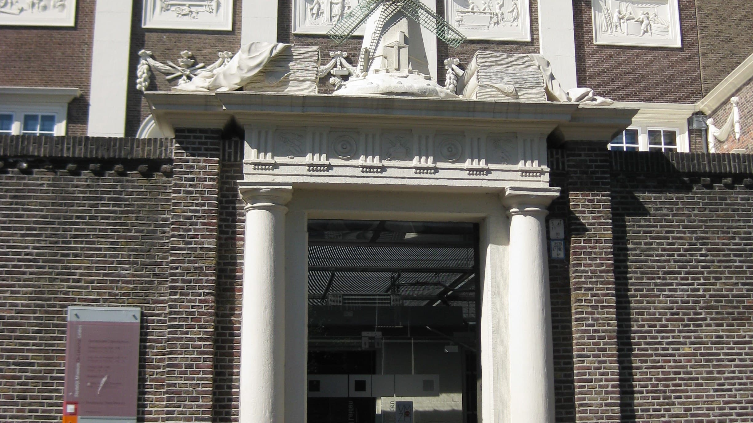 The historic entrance and decorated facade of Museum de Lakenhal in Leiden