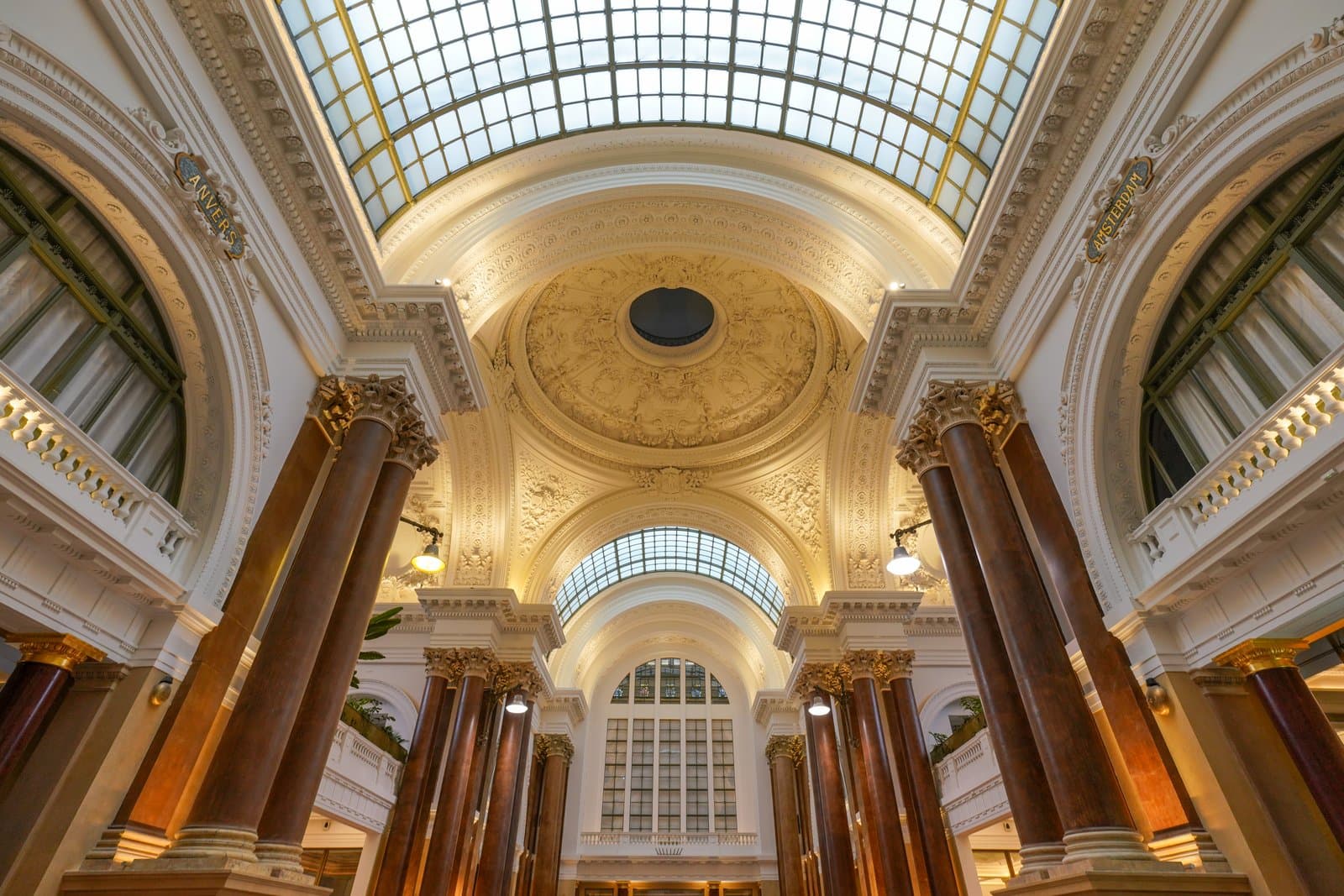 The ornate painted ceiling and glass dome inside the Bourse/Beurs building in Brussels