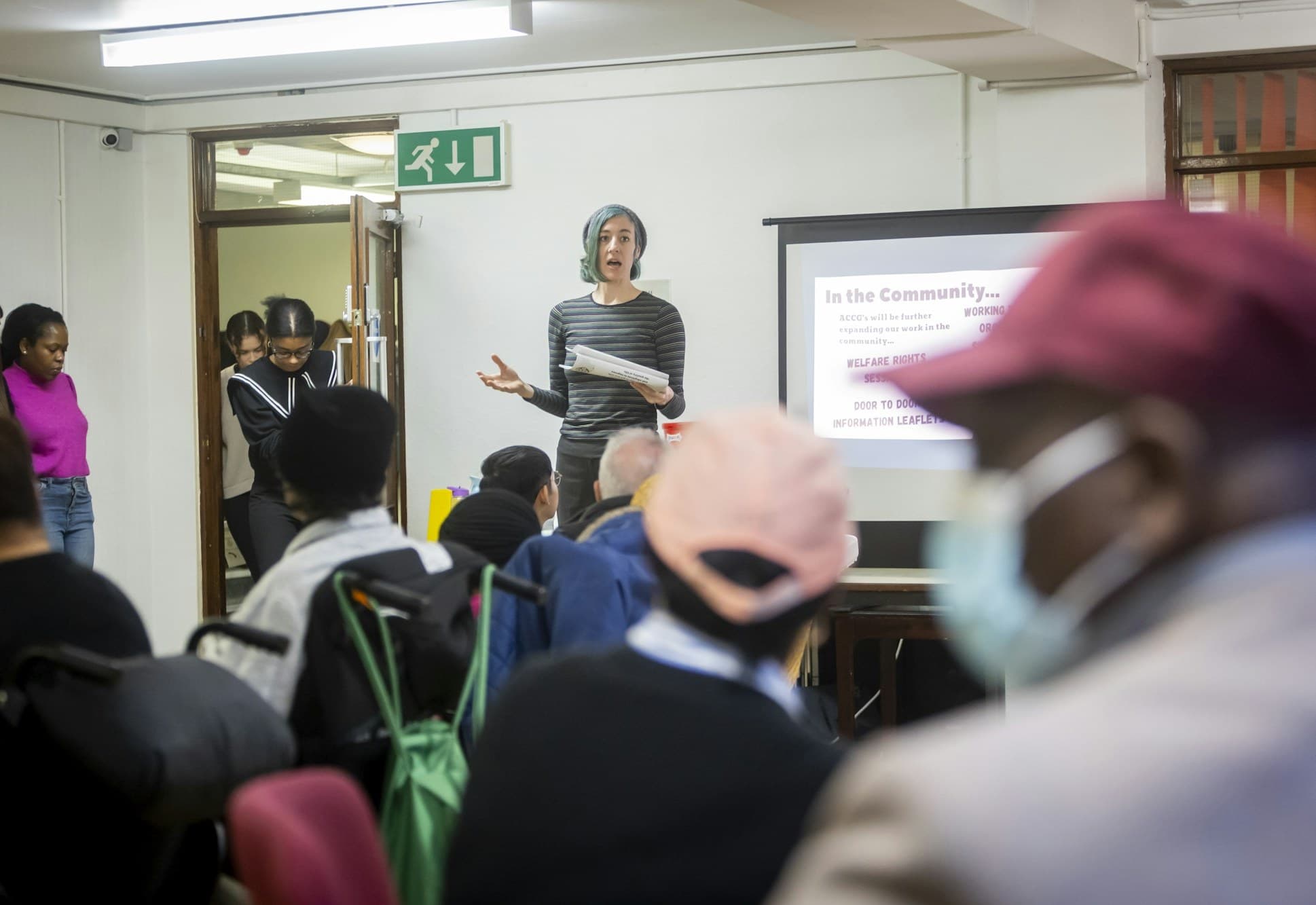 People listen to a presentation during an adult learning session